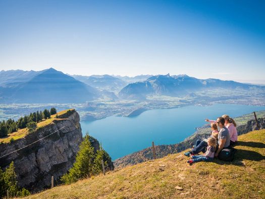 Die Familie geniesst die rundum Aussicht vom Niederhorn auf den Thunersee und die Berge